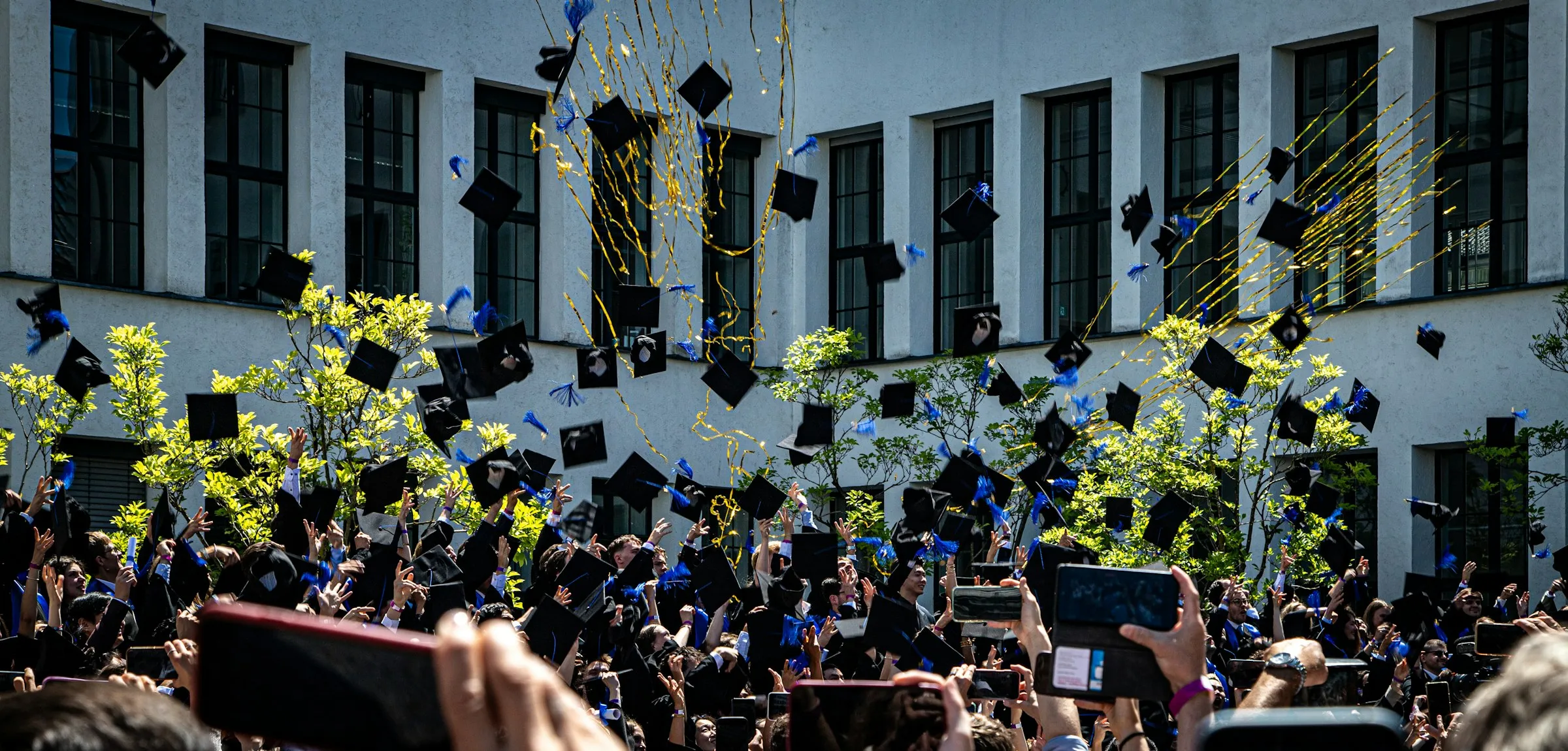 Graduates throwing their caps in the air in celebration